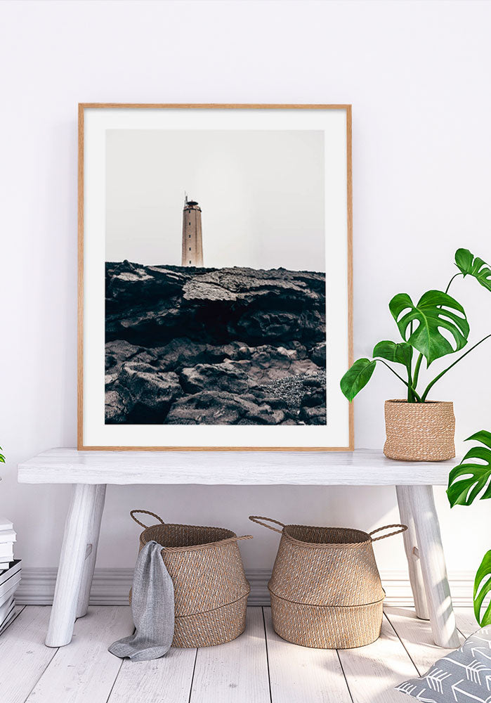 Lighthouse On Top Of Black Rocks