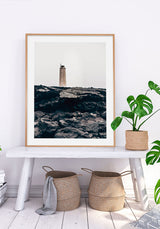 Lighthouse On Top Of Black Rocks