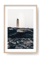 Lighthouse On Top Of Black Rocks