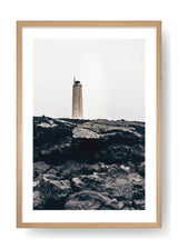 Lighthouse On Top Of Black Rocks