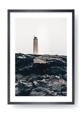 Lighthouse On Top Of Black Rocks