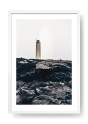 Lighthouse On Top Of Black Rocks